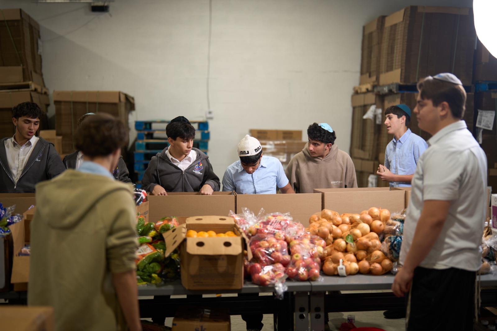 Boys filling up Shabbos boxes