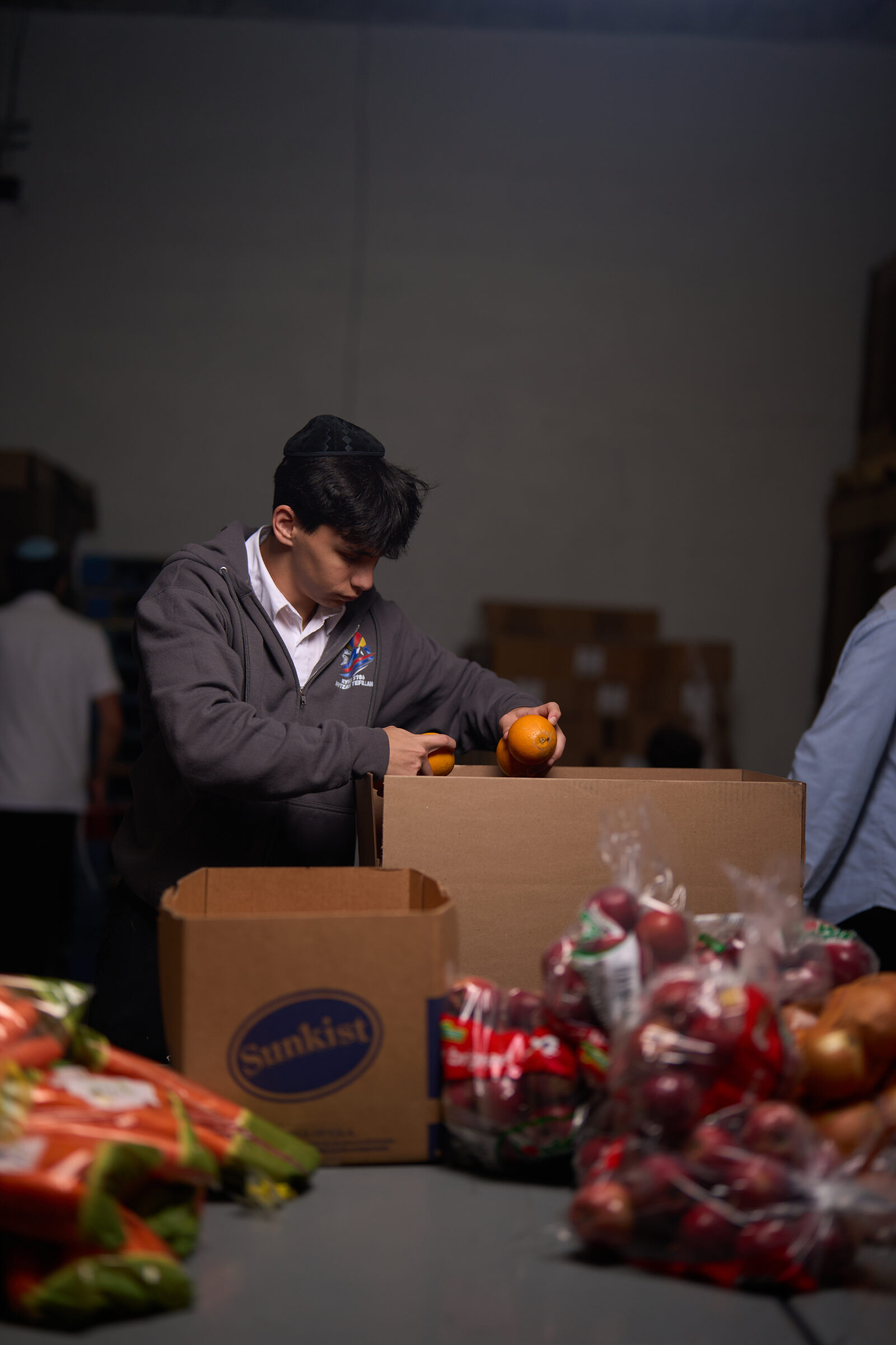 Tomchei Shabbos volunteers packing food